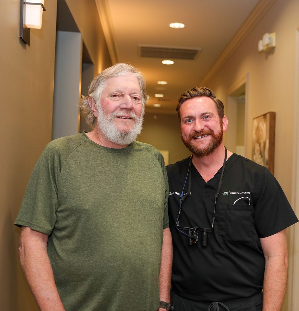 patient and doctor smiling within the dental center