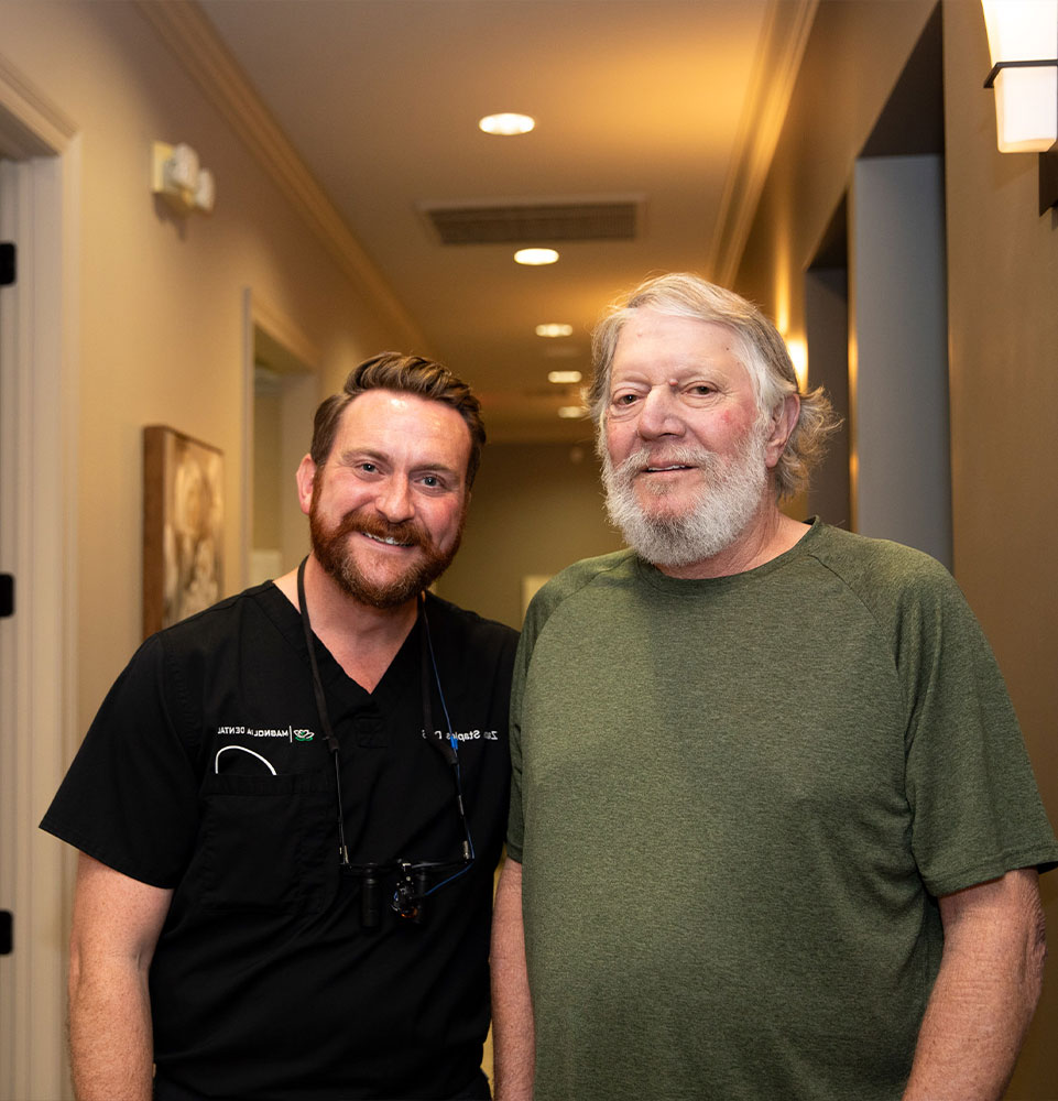 doctor and patient smiling together within the dental center smiling
